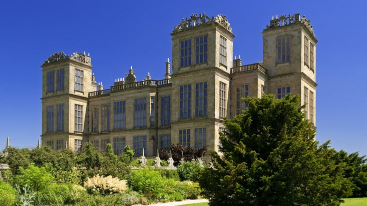 A view of Hardwick Hall with the south border in full bloom in front of the building